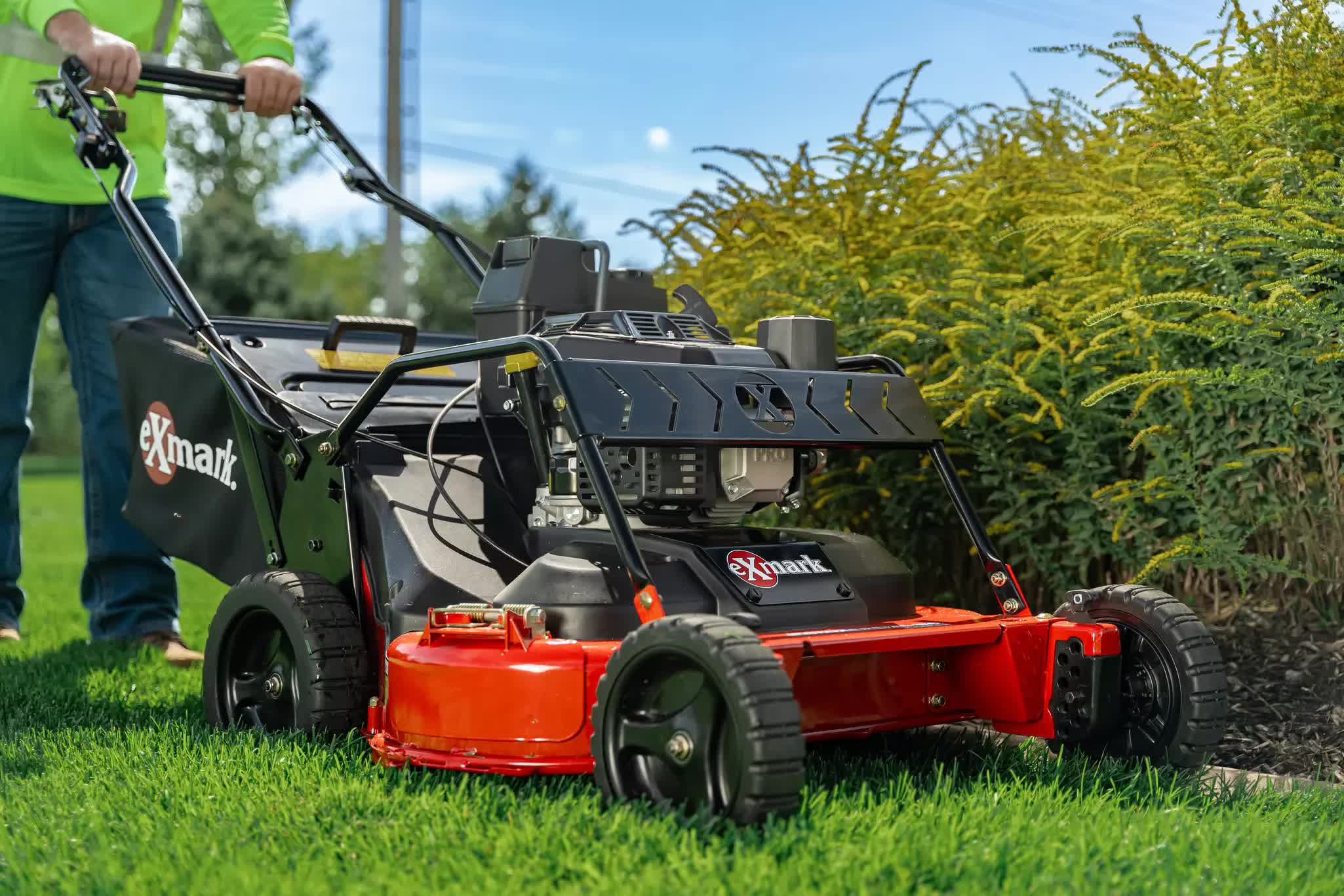 A high-quality Exmark lawnmower expertly trimming the edge of a lawn.